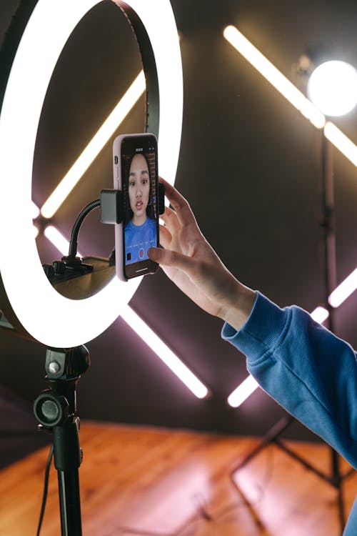 Free A Woman Recording Herself with a Smartphone Stock Photo