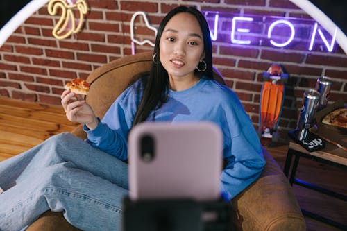 Free A Woman Recording Herself with a Smartphone  Stock Photo