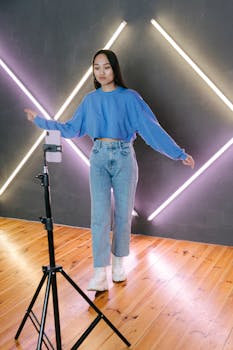 Young woman streaming a dance video using a mobile phone and tripod.