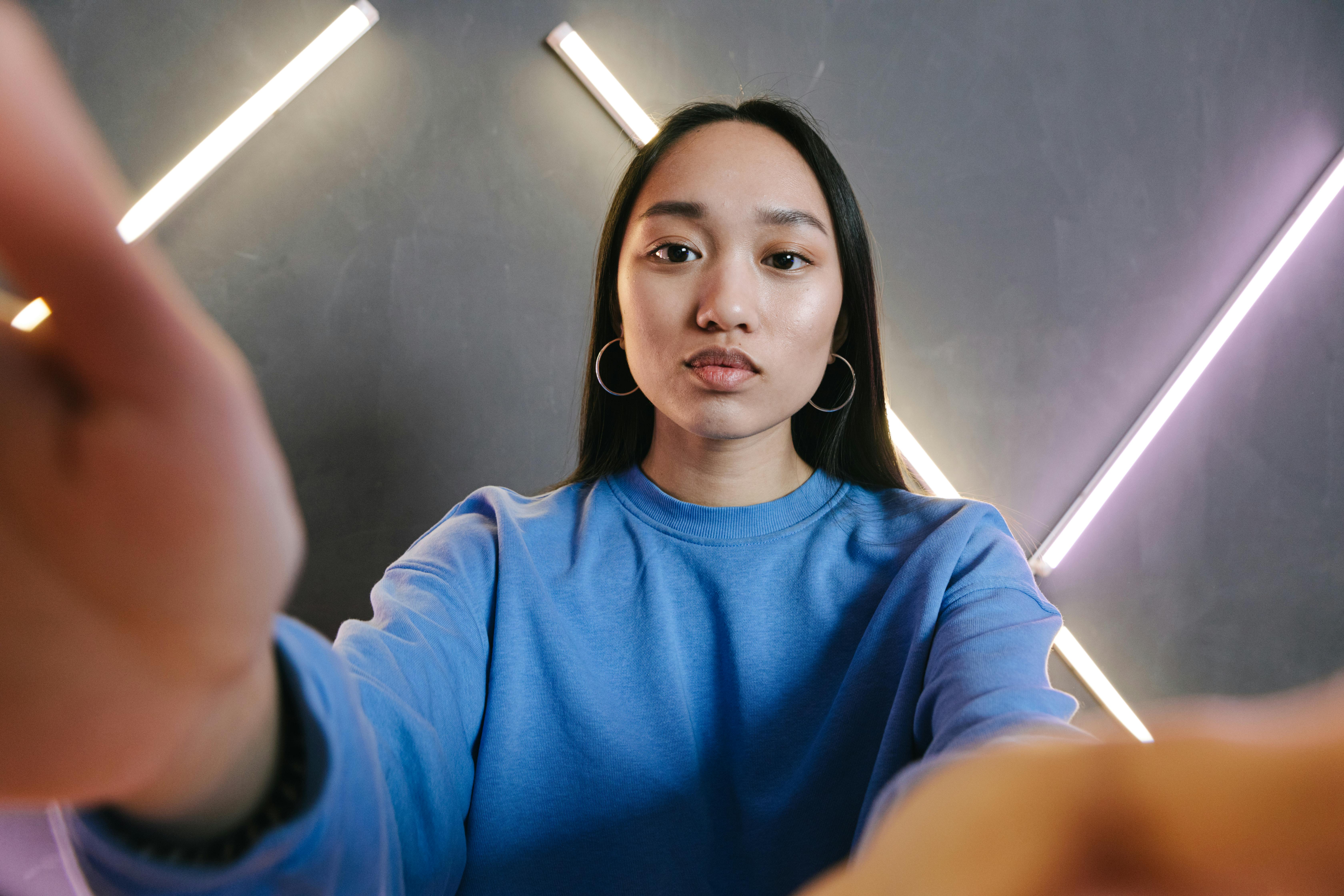 a woman in blue sweater blogging