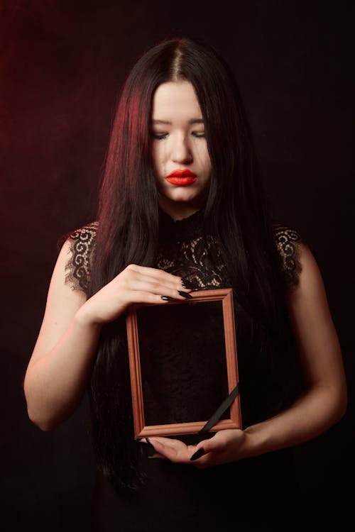 A Woman Holding a wooden Frame