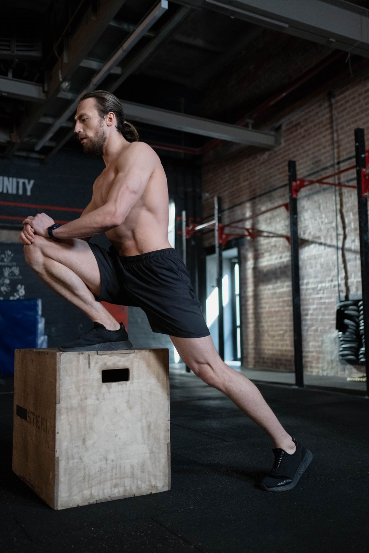 Older man performing a dumbbell chest press on a bench with controlled form