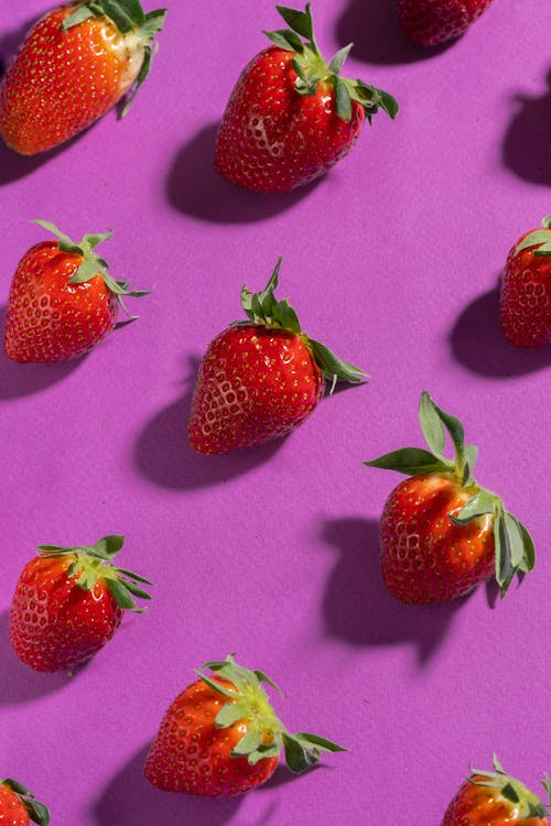 Photo of Red Strawberries on a Purple Surface