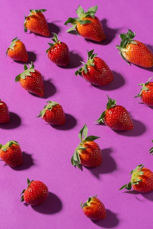 Close-Up Photo of Delicious Strawberries on a Pink Surface