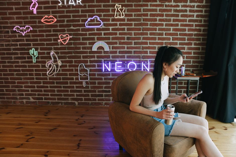 Content creator in comfortable setting with neon lights