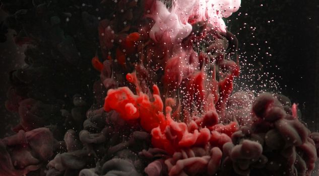 Vibrant abstract image featuring an artistic flow of colored inks and bubbles in water.