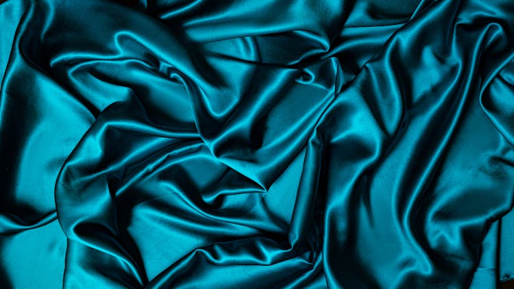 Teal Textile On Flat Surface