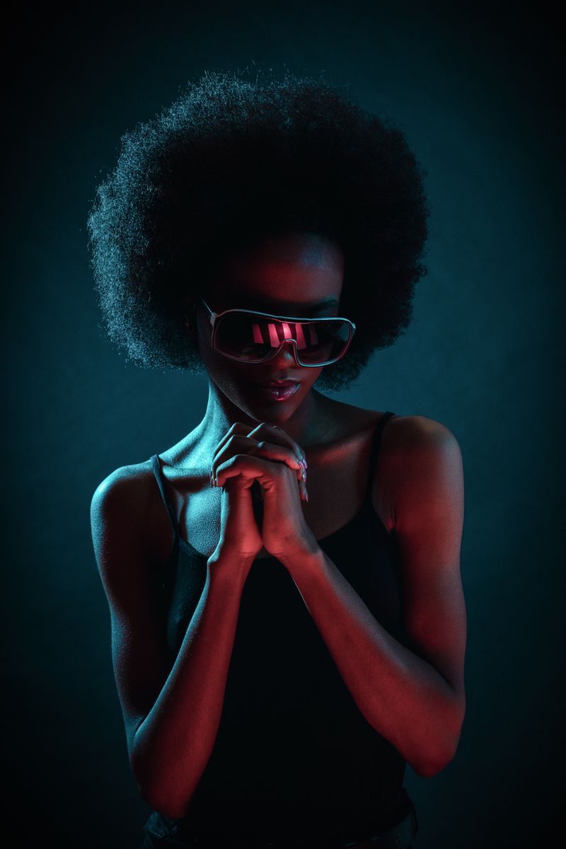 Model in neon light wearing statement sunglasses