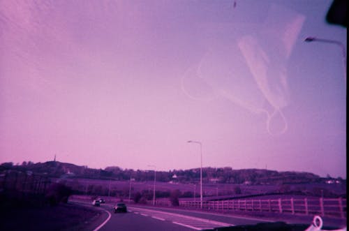 Film Photograph of a Highway taken from the Inside of the Car