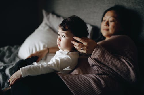 Free A Mother and Her Child on a Bed Stock Photo