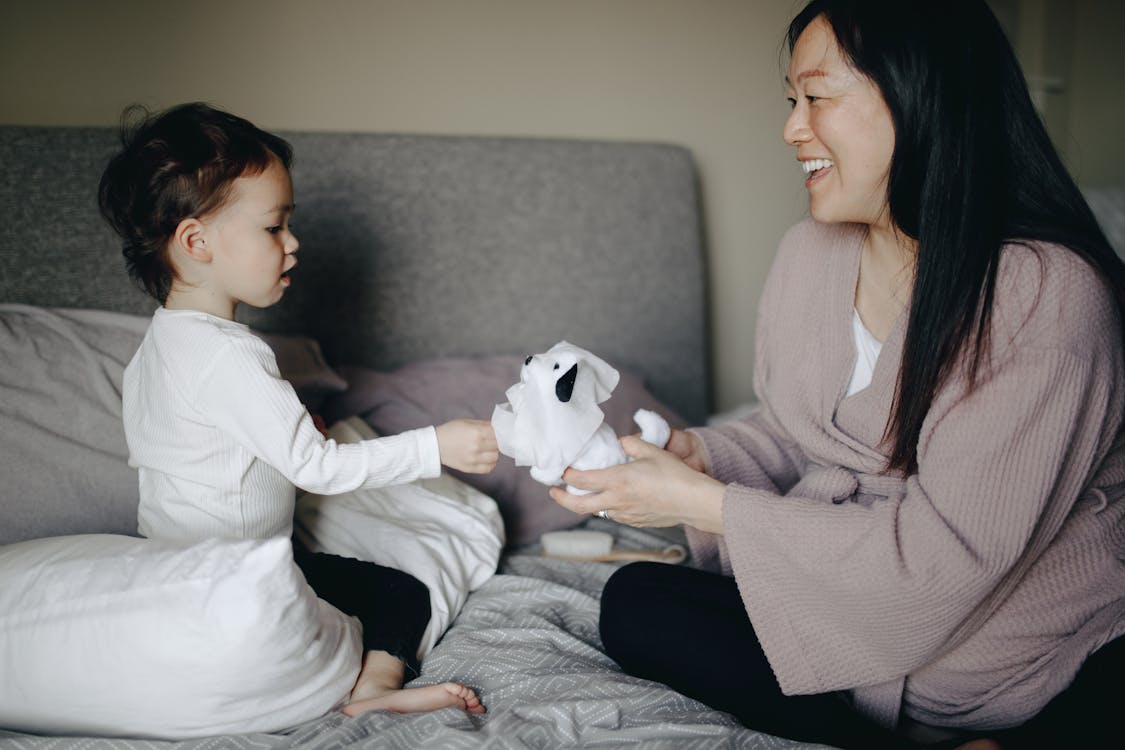 Free Mother And Child Playing Before Bedtime Stock Photo