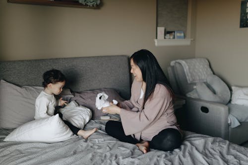 Free Mother And Child Playing At Bedtime Stock Photo