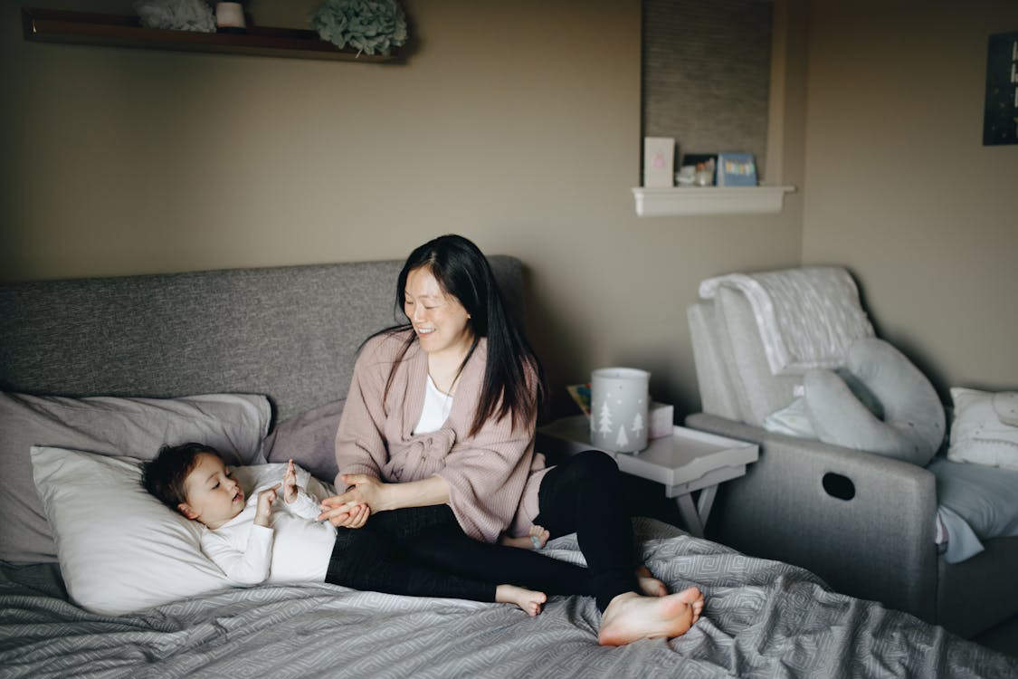 Woman Putting Her Child To Sleep