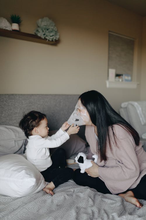 Mother And Child Playing During Bedtime