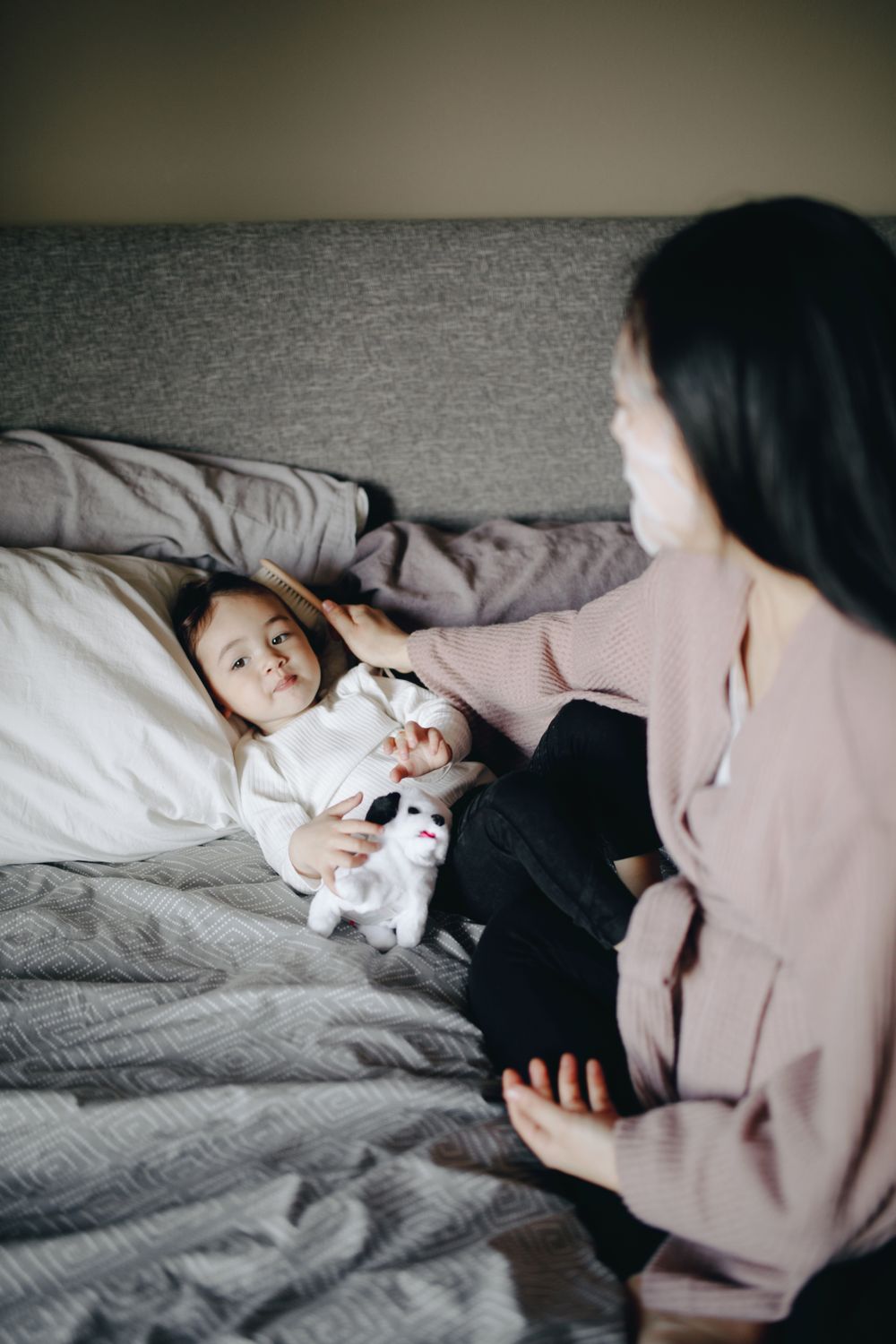 A parent settling their child to sleep with a story