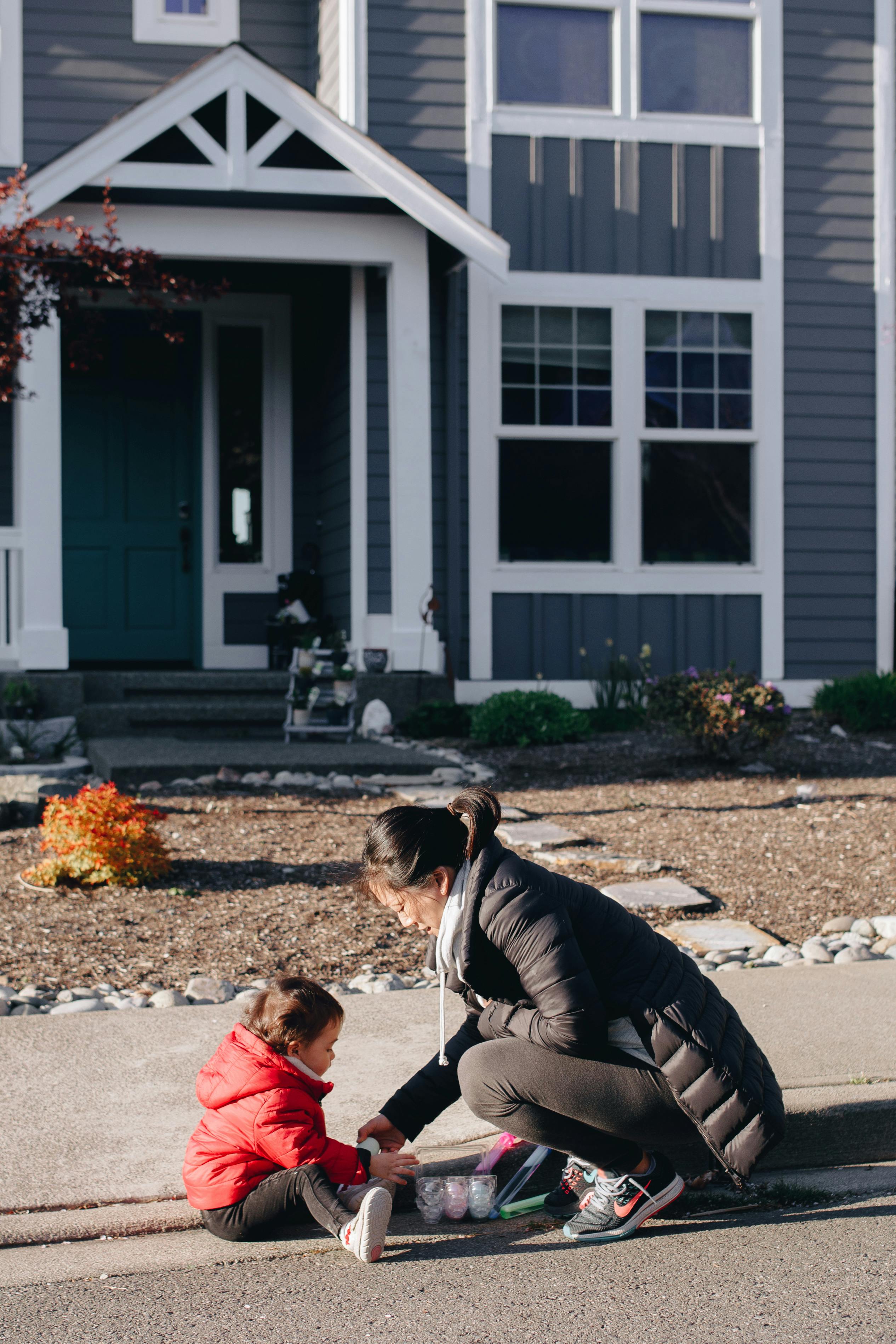 mother and child sitting along the street