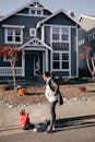 A Child Sitting On Sidewalk Crying Beside Her Mother