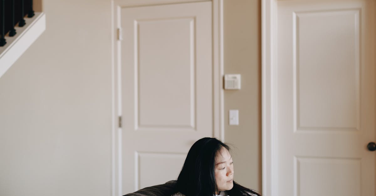 Woman Sitting On Gray Sofa Beside Her Dog