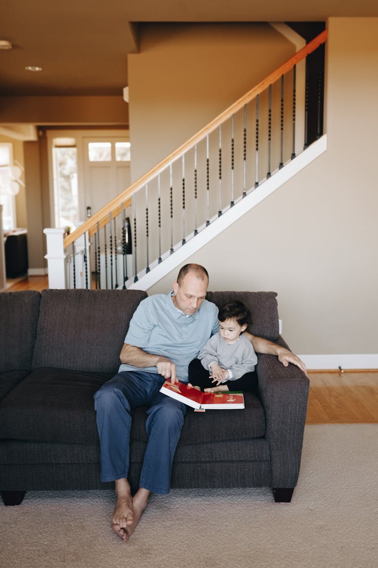 Father Reading A Book To His Child