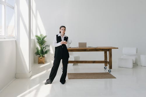 

A Woman Using Her Smartphone in an Office