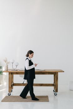 Woman Walking on Rug Near the Wooden Table