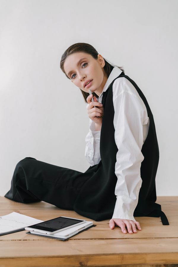 Woman wearing a structured vest as a top with wide-leg pants