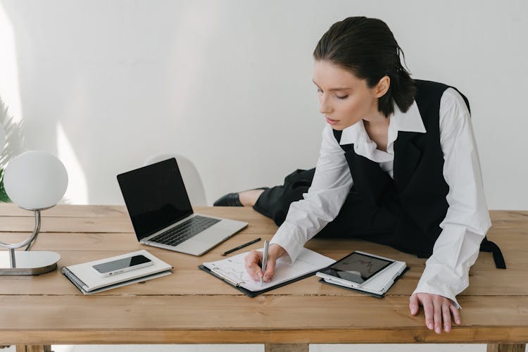 Woman Writing On Paper