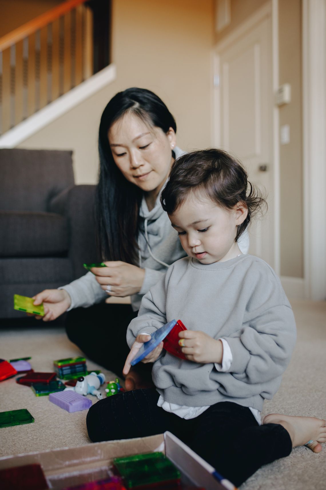 Mother and young child sharing a colorful play and learning moment at home