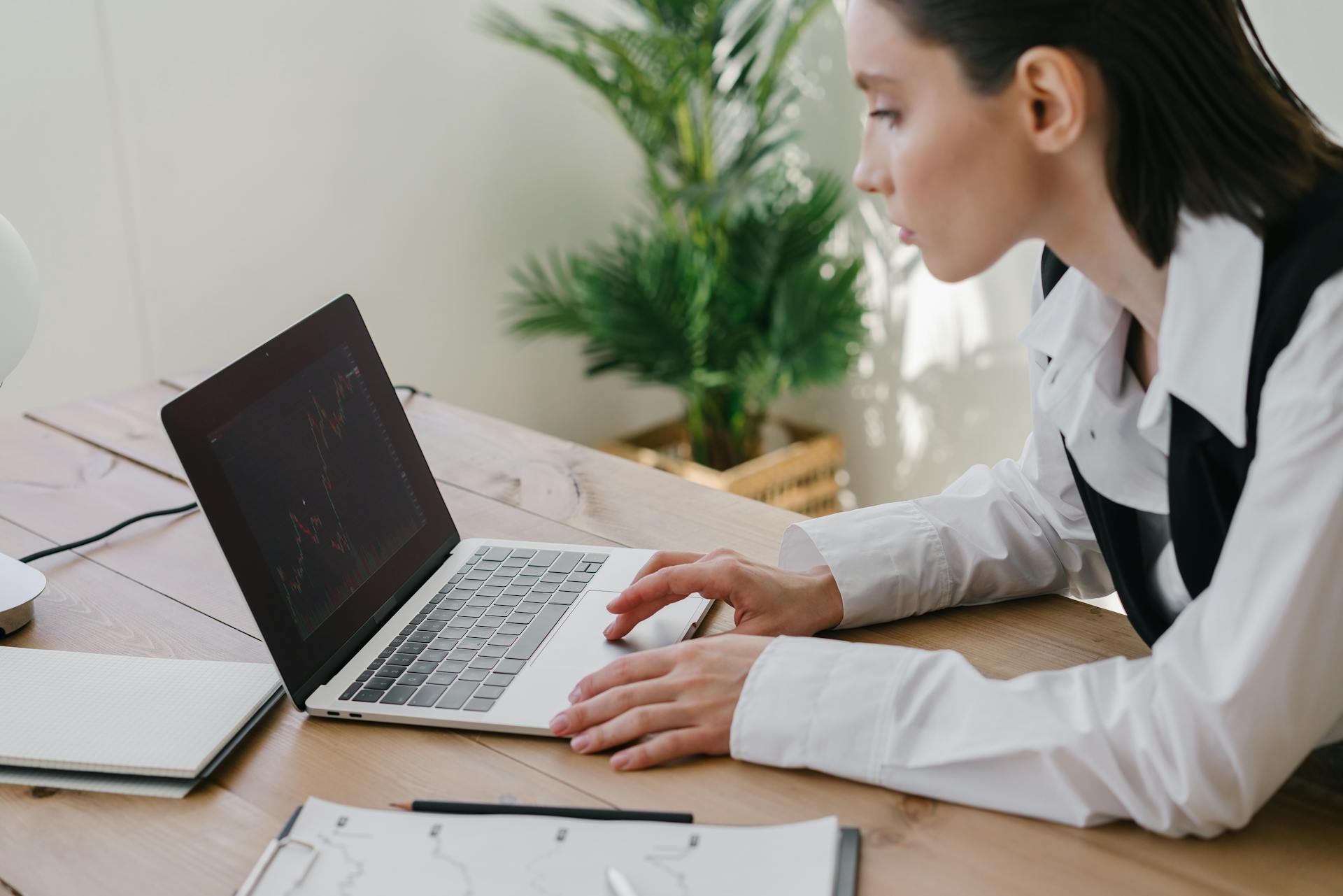 A Woman Looking at a Chart on the Laptop Screen