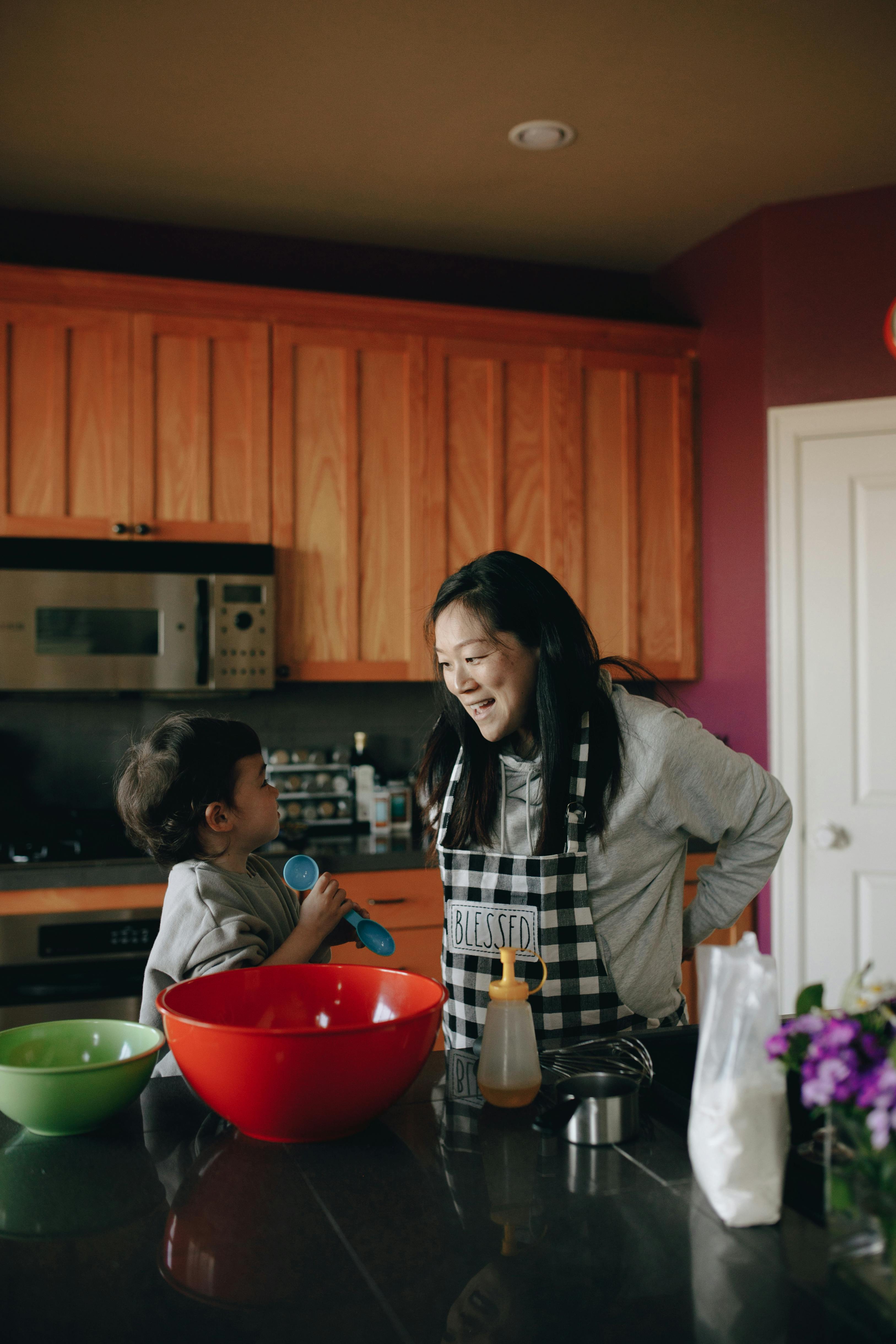 mother and baby baking together in the kitchen