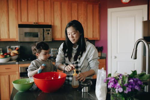 Free Mother And Child Baking In Kitchen Stock Photo