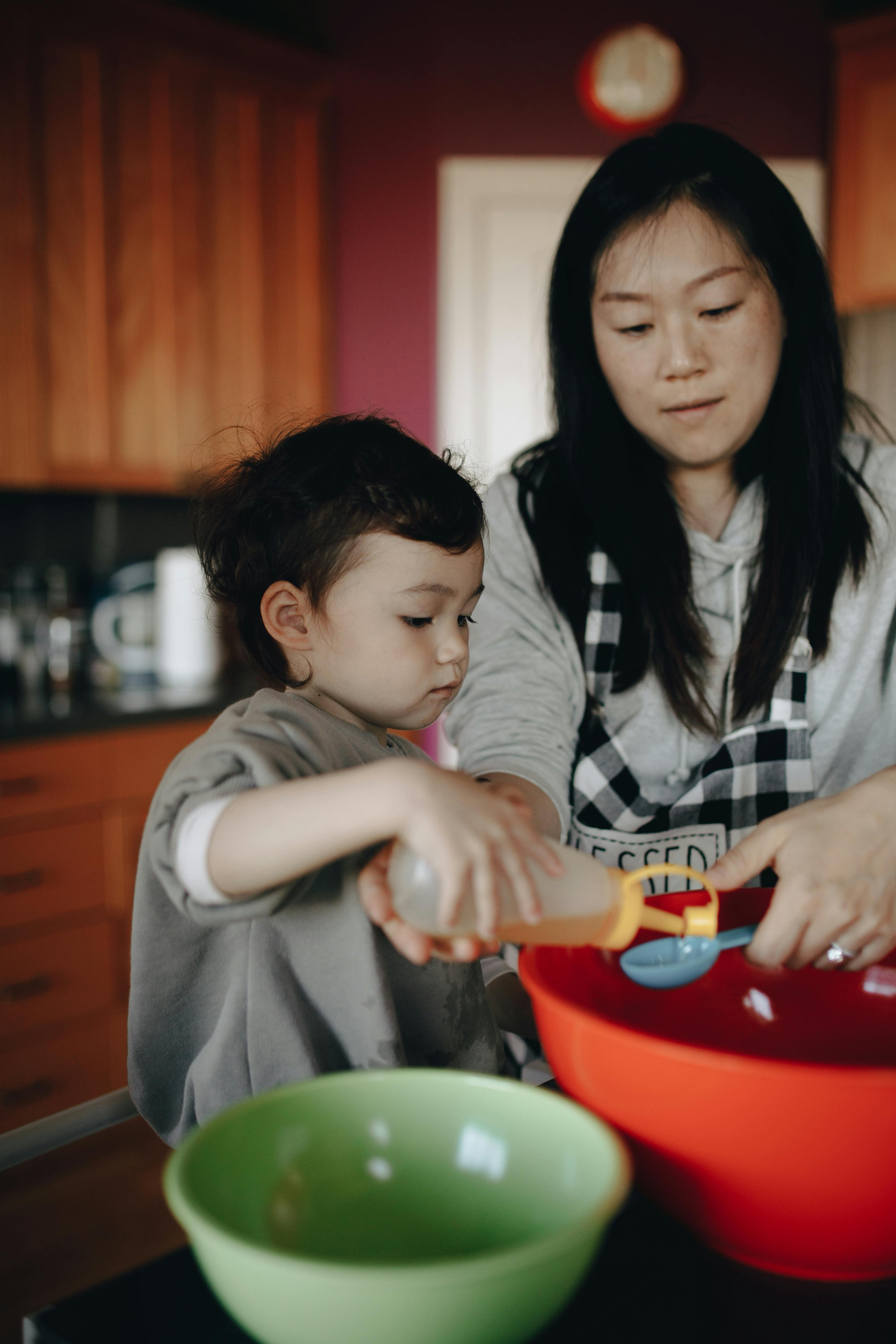 mother and baby baking together in the kitchen