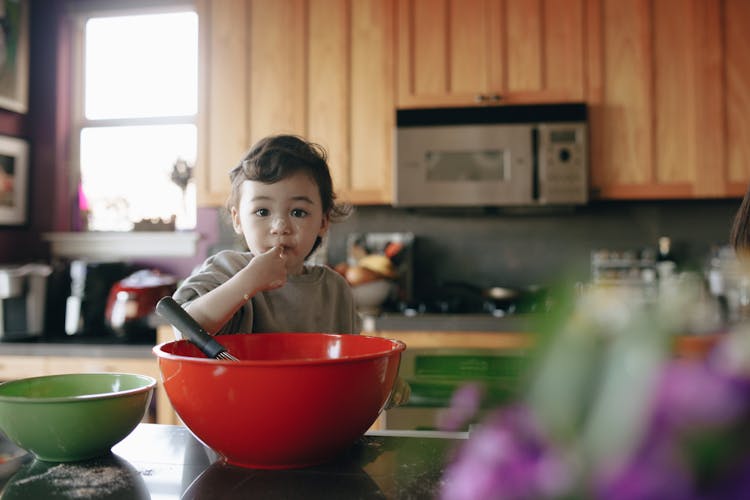 A Child Baking In The Kitchen