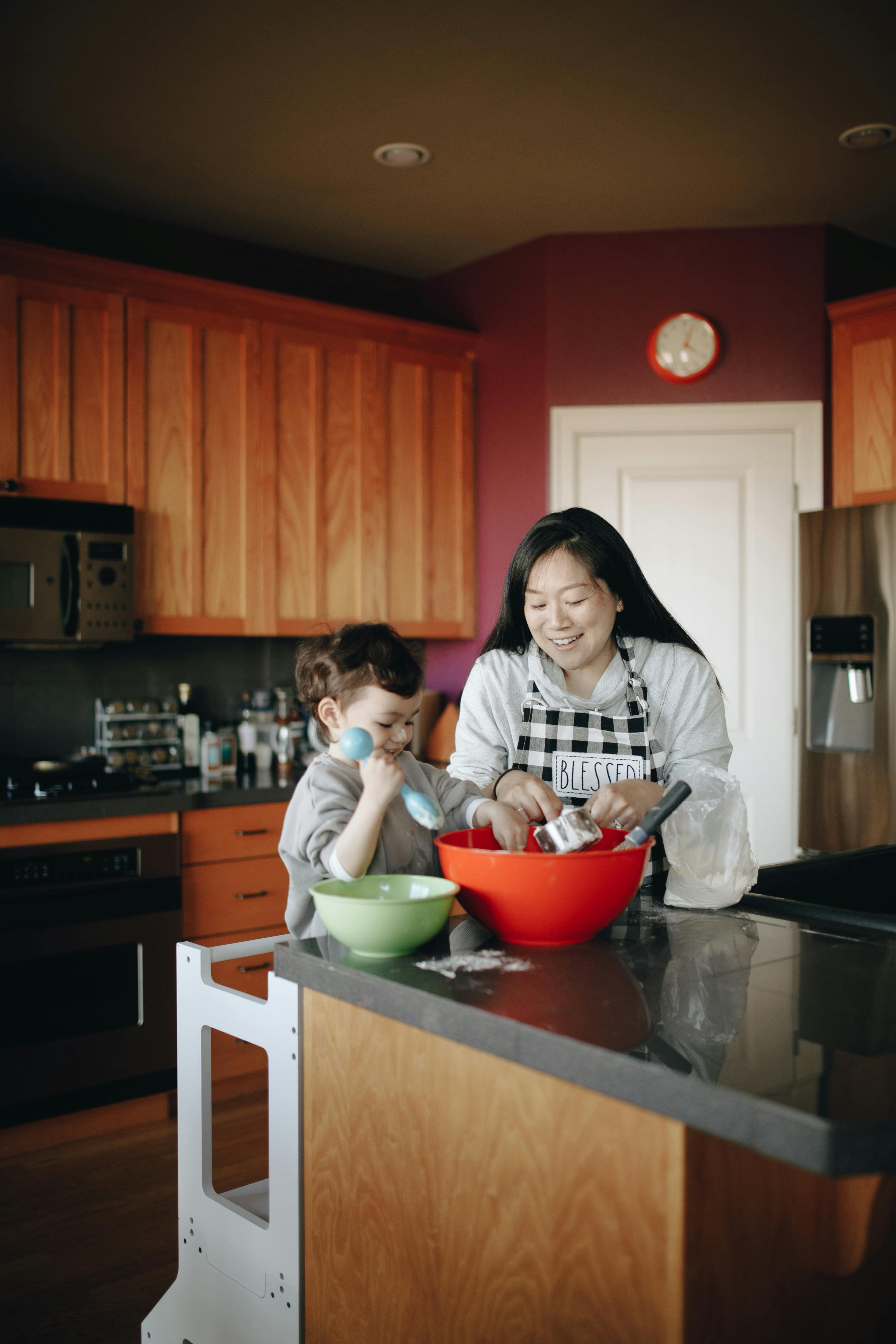 mother and baby baking together in the kitchen