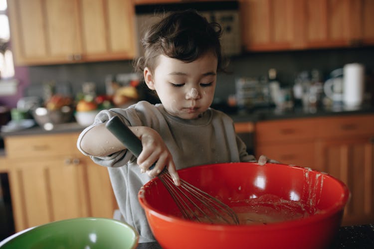 A Little Child Baking In Kitchen