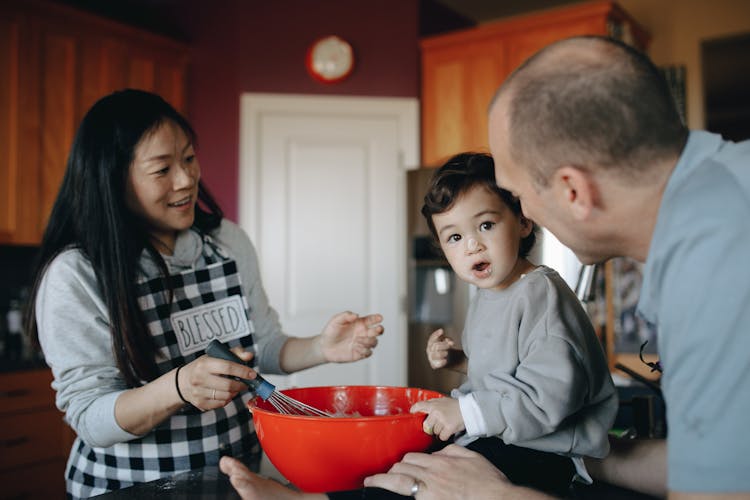 A Family Baking Together In The Kitchen