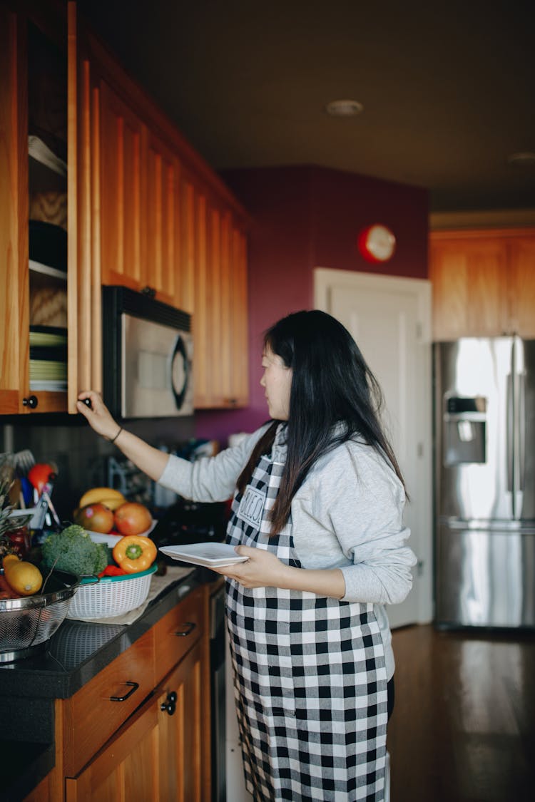 Woman Doienng Housework In The Kitch