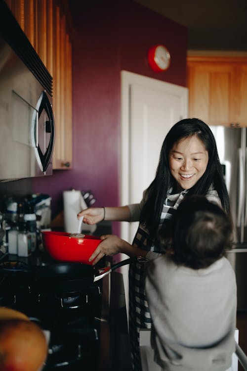 Mother Cooking In The Kitchen With Her Child