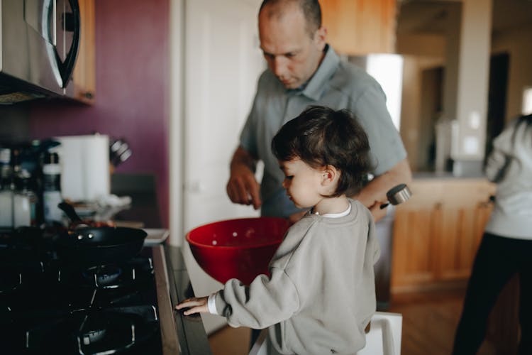 A Father And Child Cooking In The Kitchen