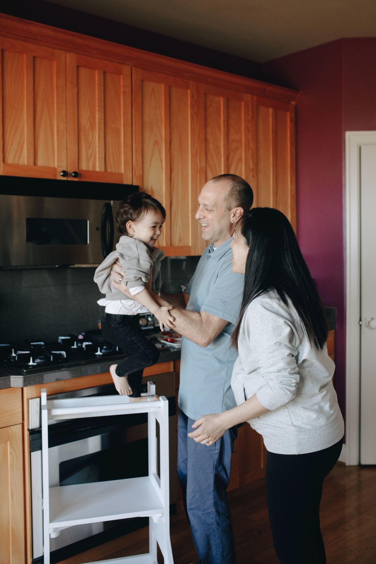 Family cooking together in a bright modern kitchen