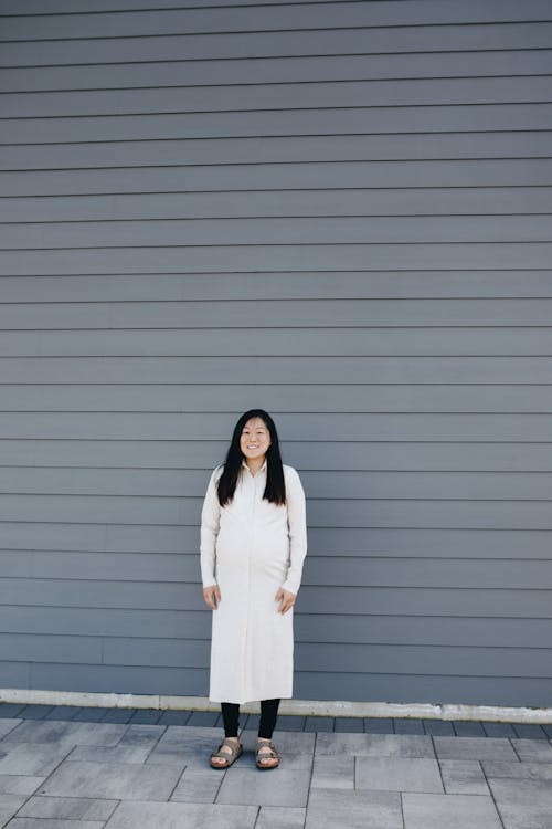 Woman Standing Near A Gray Wall