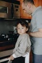 Father Cooking In The Kitchen With Her Child