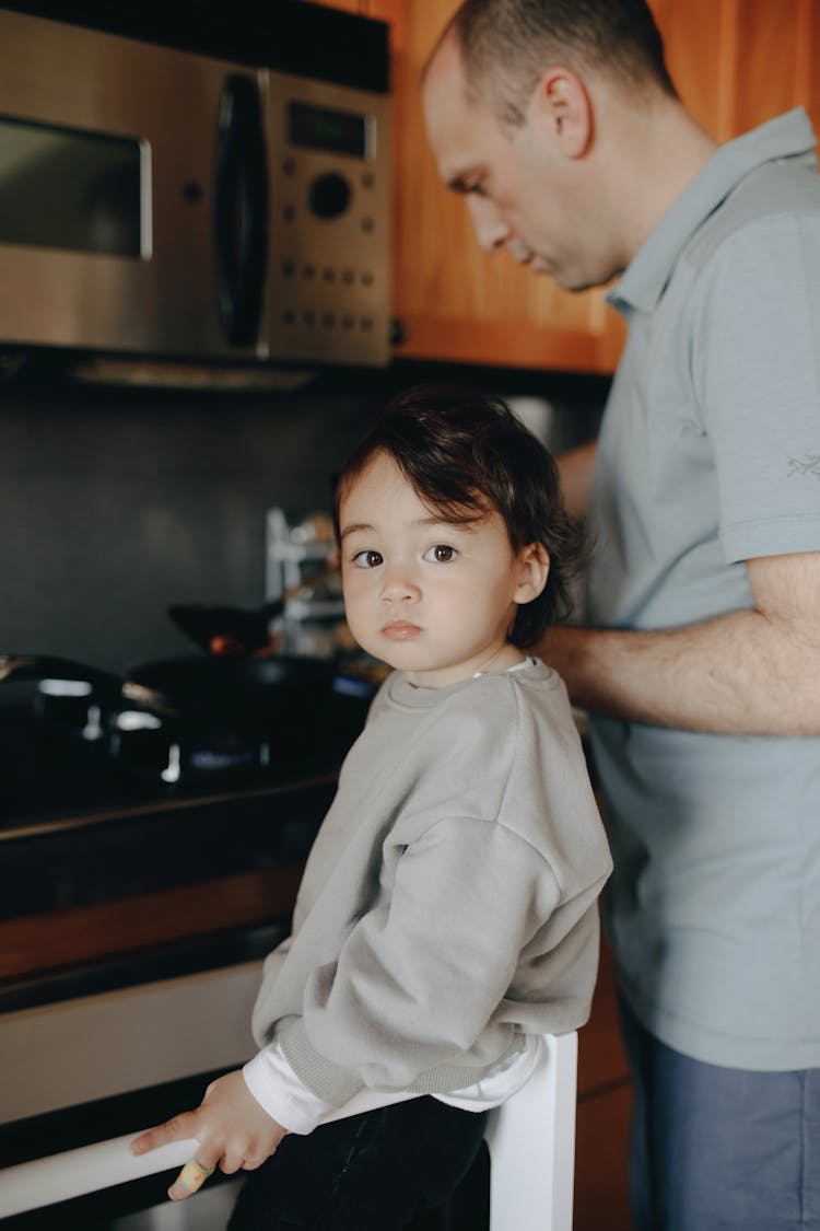 Father Cooking In The Kitchen With Her Child