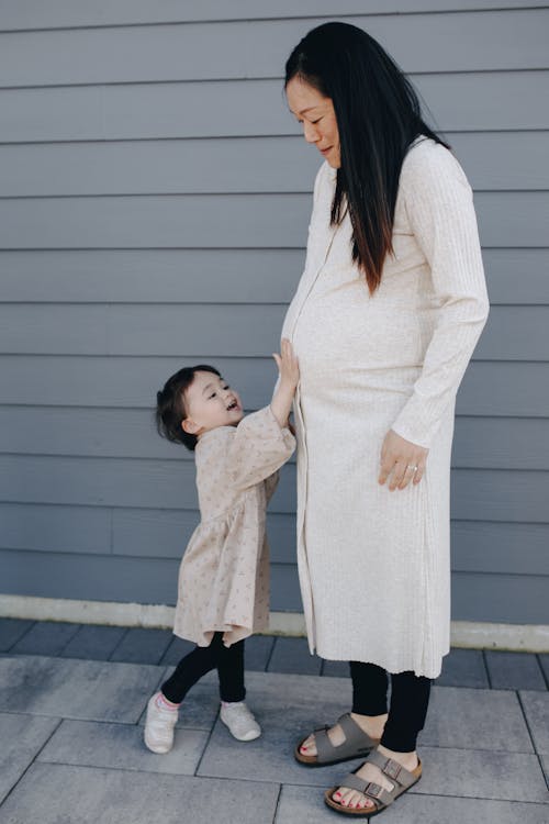 Little Girl Touching Her Mother's Tummy