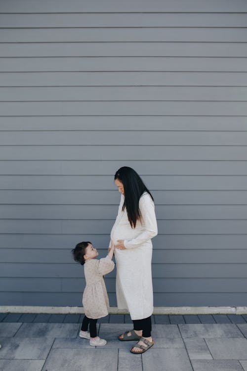 Free Little Girl Touching Her Mother's Tummy Stock Photo