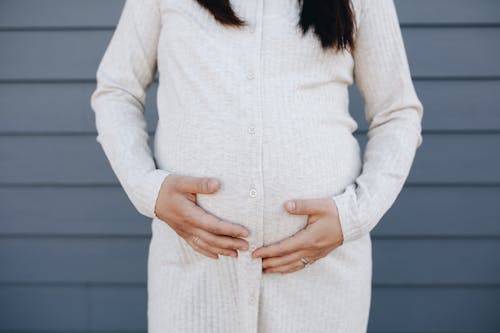 Crop Photo Of Pregnant Woman Holding Her Tummy