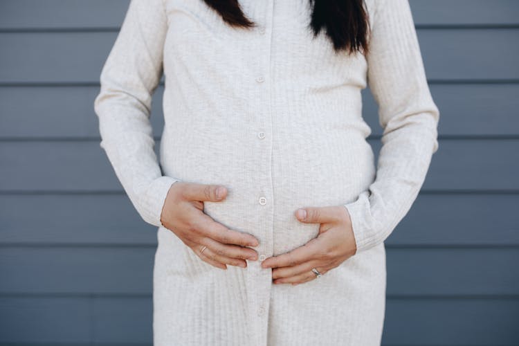 Crop Photo Of Pregnant Woman Holding Her Tummy