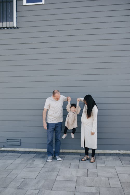 A Couple Playing With Their Daughter