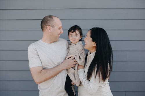 Couple Carrying Their Baby Girl