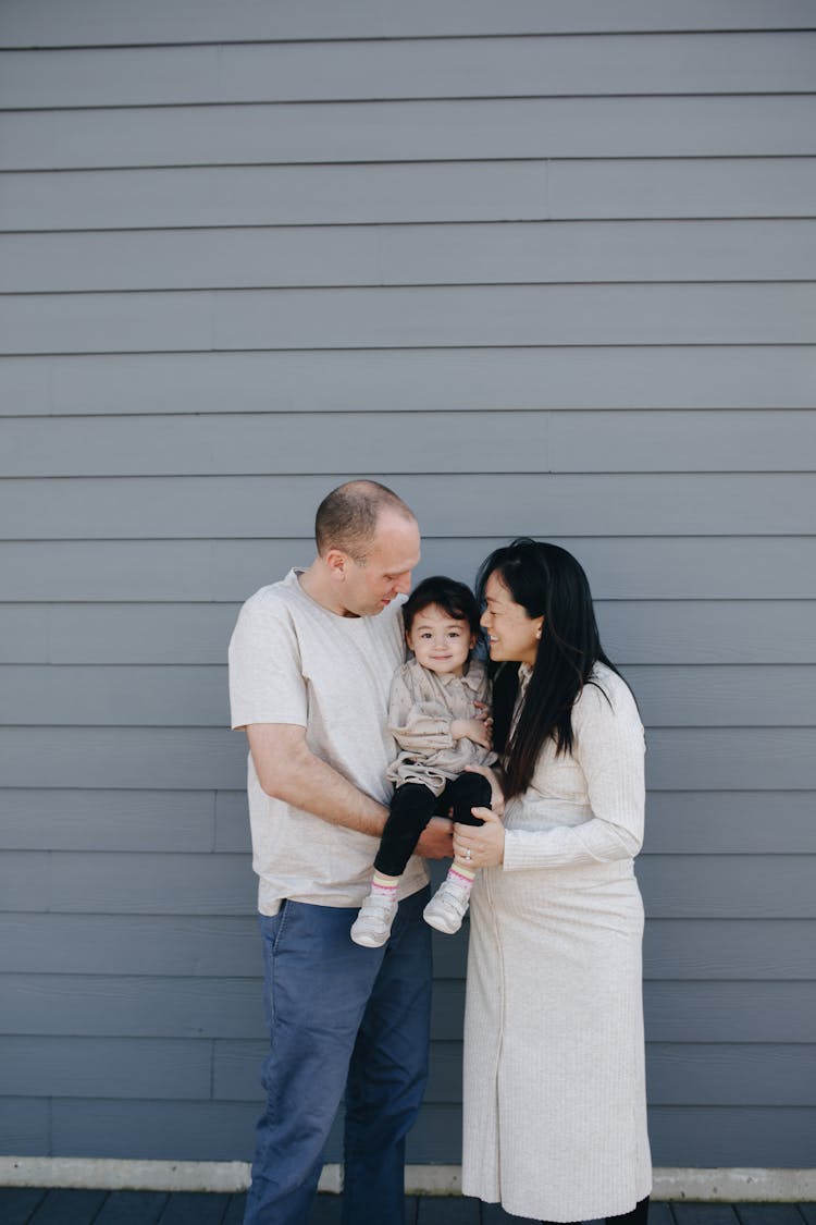 Couple Carrying Their Baby Girl